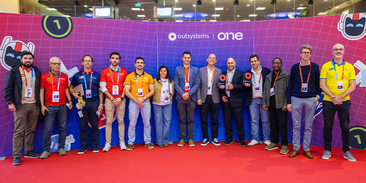 Noesis team and DHL partners posing with awards received at the OutSystems ONE Conference