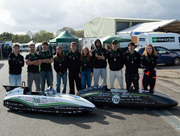 Técnico’s Mechanical Engineering Sustainability Project team standing next to their competition vehicles.