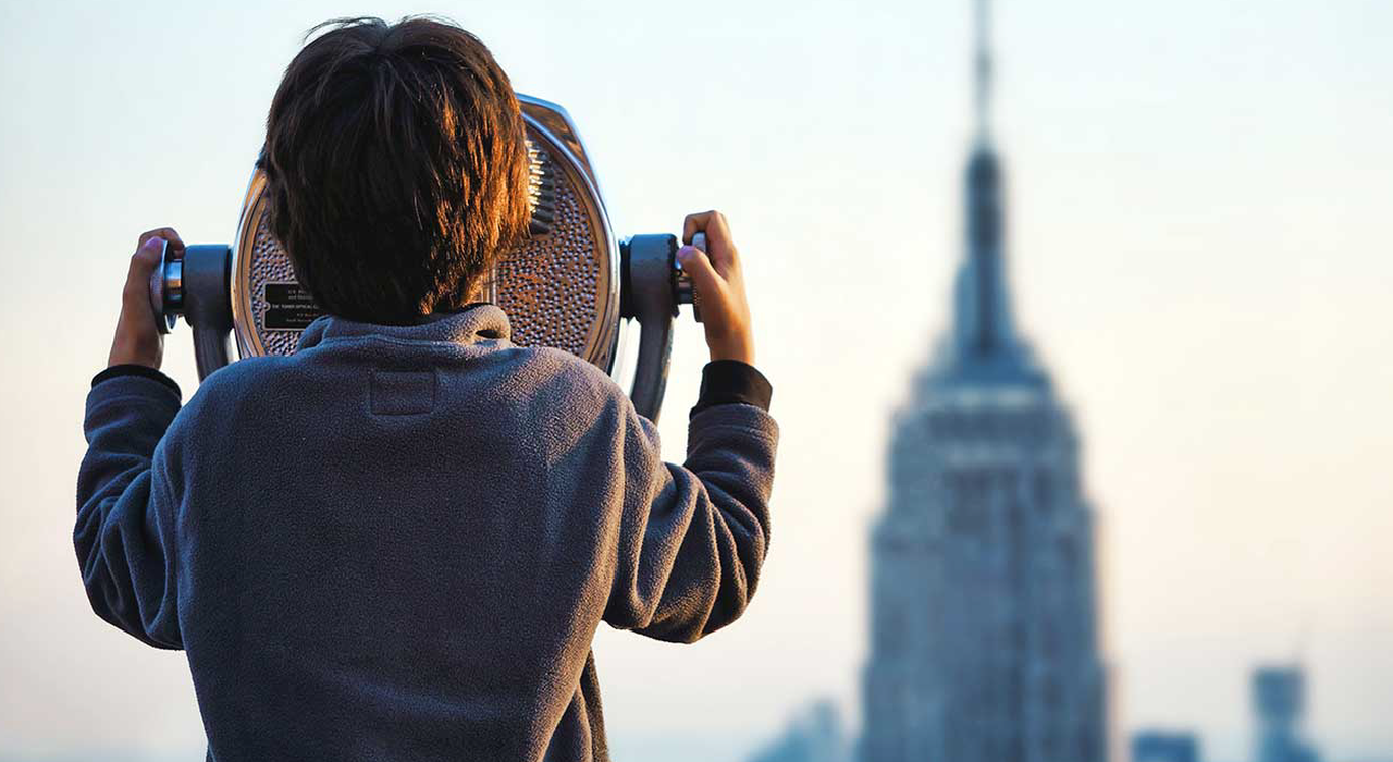 Header, Kid using sightseeing binoculars represents our capacity to prevent all cyber attacks